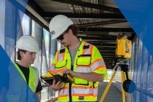 construction workers with trimble tablet