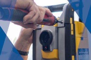 technician repairing a total station